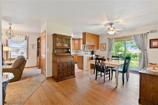 3028 Wachter Ave, Lower Burrell, PA 15068 - dining area with light wood-type flooring, ceiling fan, and baseboards