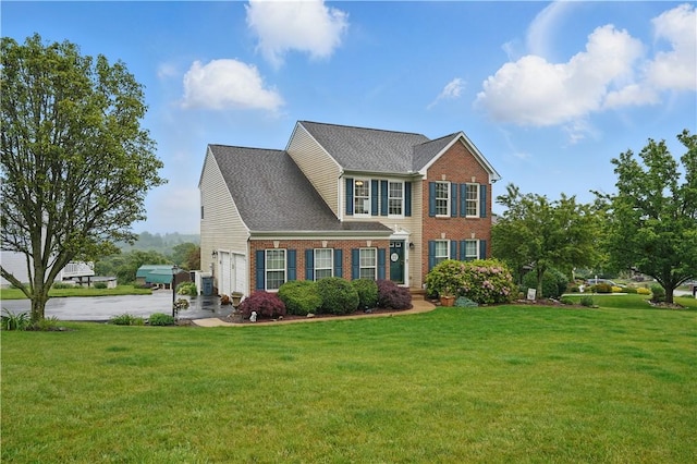 923 Arberdeen Dr, Hempfield Twp Wml, PA 15601 - colonial-style house featuring brick siding, a front yard, and driveway