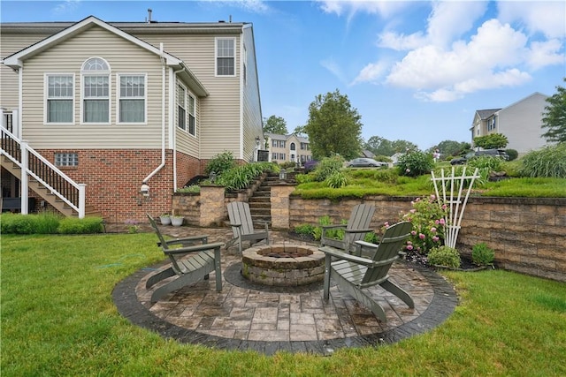 923 Arberdeen Dr, Hempfield Twp Wml, PA 15601 - rear view of property with an outdoor fire pit, a lawn, stairs, and a patio