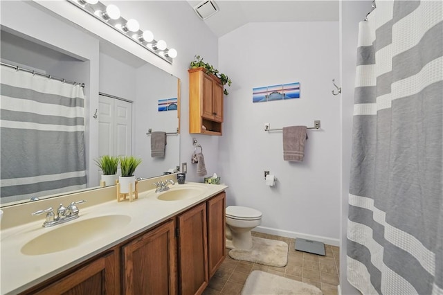 923 Arberdeen Dr, Hempfield Twp Wml, PA 15601 - full bathroom with double vanity, toilet, lofted ceiling, baseboards, and tile patterned floors