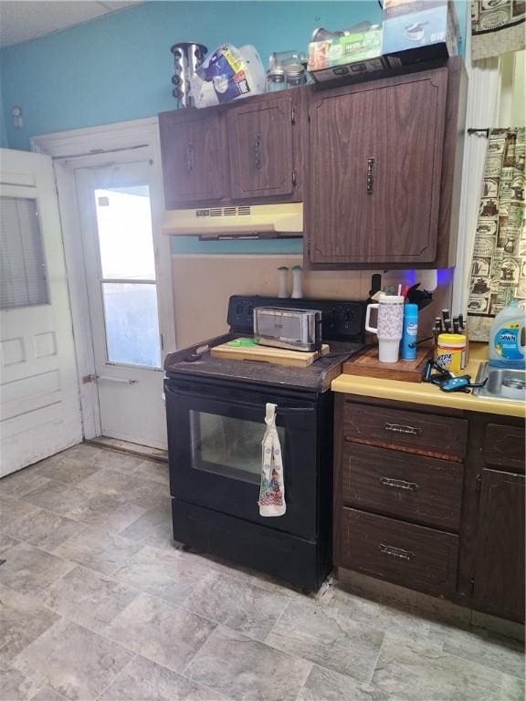 595 N Richhill St, Waynsbrg/Frankln Twp, PA 15370 - kitchen featuring black electric range, under cabinet range hood, stone finish floors, dark brown cabinetry, and light countertops