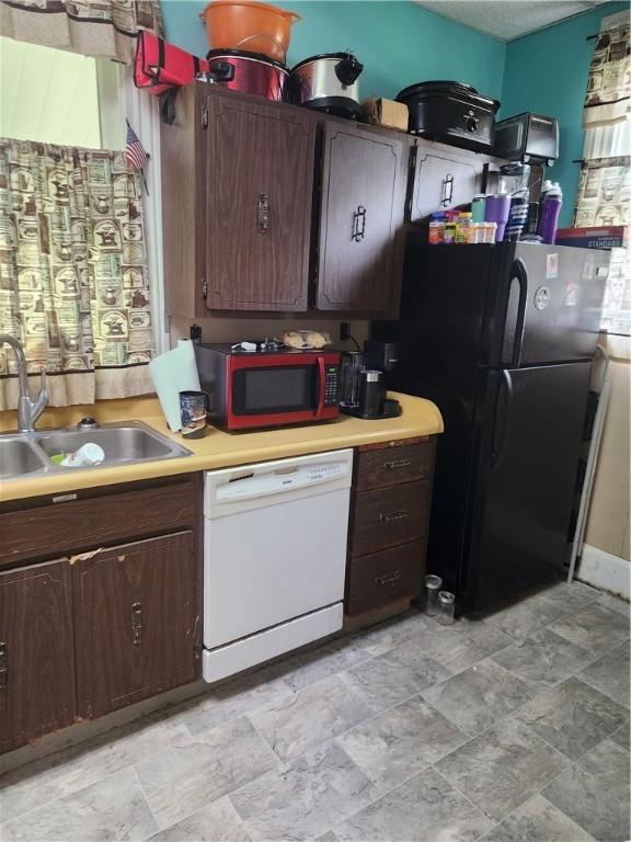 595 N Richhill St, Waynsbrg/Frankln Twp, PA 15370 - kitchen featuring dishwasher, freestanding refrigerator, a sink, light countertops, and stone finish floors