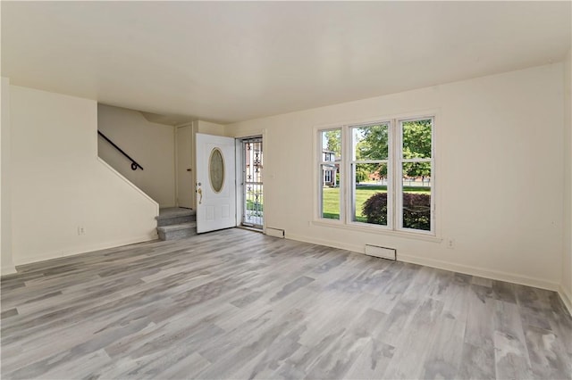 2603 19th St Unit E, Patterson Twp, PA 15010 - unfurnished living room featuring stairway, light wood finished floors, and baseboards