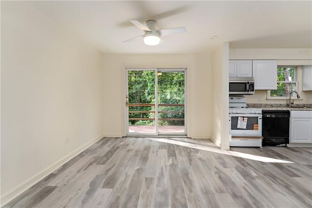 2603 19th St Unit E, Patterson Twp, PA 15010 - kitchen featuring black dishwasher, stainless steel microwave, white gas stove, baseboards, and light wood-style flooring