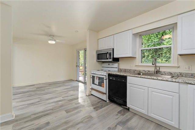 2603 19th St Unit E, Patterson Twp, PA 15010 - kitchen featuring black dishwasher, white gas stove, a sink, stainless steel microwave, and white cabinetry