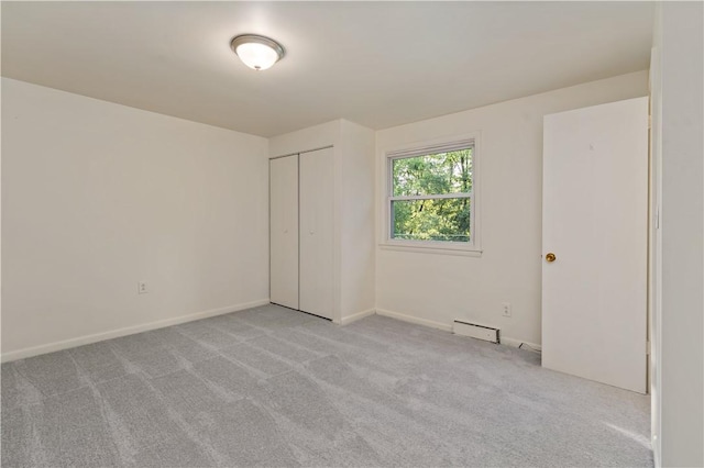 2603 19th St Unit E, Patterson Twp, PA 15010 - unfurnished bedroom featuring a baseboard radiator, carpet flooring, a closet, and baseboards