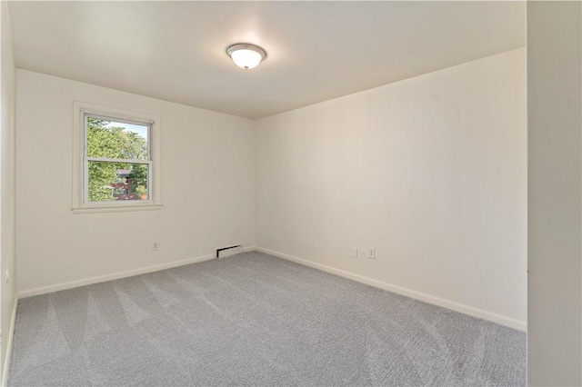 2603 19th St Unit E, Patterson Twp, PA 15010 - empty room with light colored carpet, baseboards, and a baseboard heating unit
