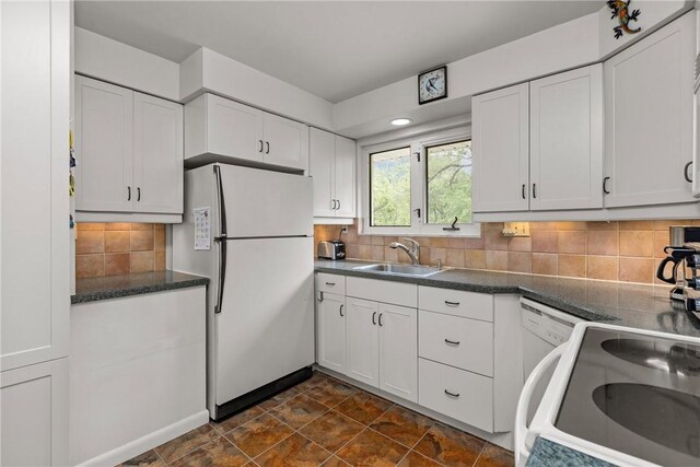 157 Kings Dale Rd, Churchill Boro, PA 15221 - kitchen featuring freestanding refrigerator, a sink, white cabinetry, dark countertops, and backsplash
