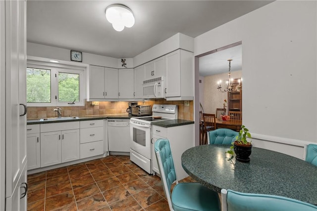 157 Kings Dale Rd, Churchill Boro, PA 15221 - kitchen with white appliances, a sink, dark countertops, backsplash, and white cabinetry