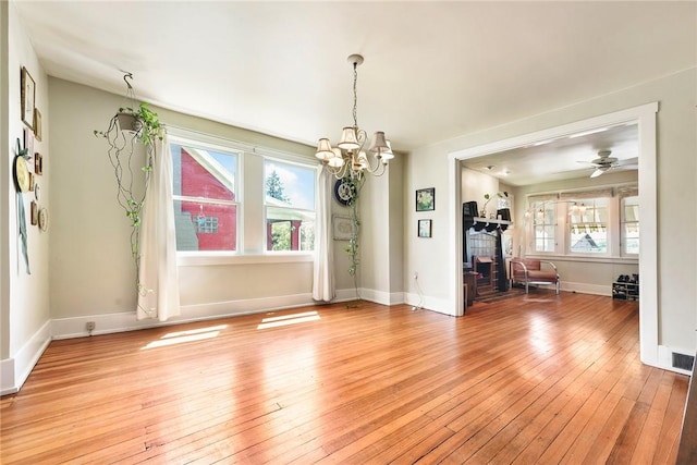 302 3rd St N, Versailles, PA 15137 - unfurnished dining area featuring light wood finished floors, a chandelier, baseboards, and a ceiling fan
