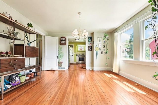 302 3rd St N, Versailles, PA 15137 - unfurnished dining area featuring a chandelier, light wood-type flooring, and baseboards