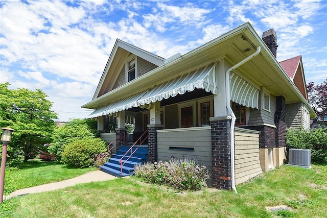 302 3rd St N, Versailles, PA 15137 - view of front facade featuring central AC, a chimney, a front lawn, and a porch