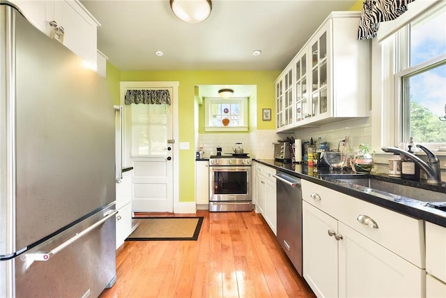302 3rd St N, Versailles, PA 15137 - kitchen featuring appliances with stainless steel finishes, tasteful backsplash, white cabinetry, light wood finished floors, and recessed lighting