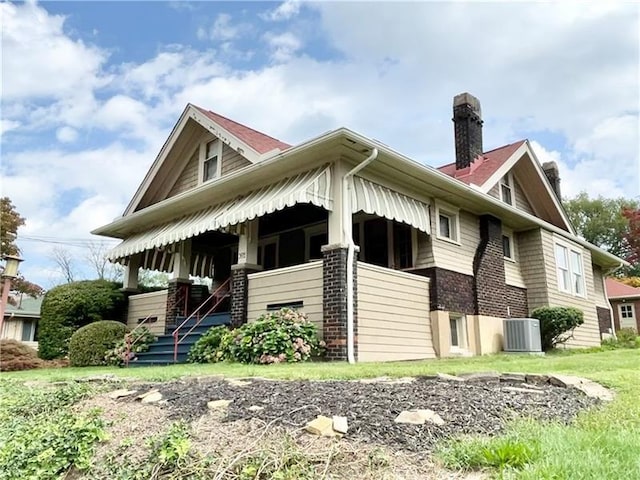 302 3rd St N, Versailles, PA 15137 - view of home's exterior with a chimney, covered porch, and central AC unit