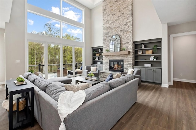 9660 Goehring Rd, Cranberry Twp, PA 16066 - living room with a towering ceiling, dark wood-style flooring, baseboards, and a fireplace