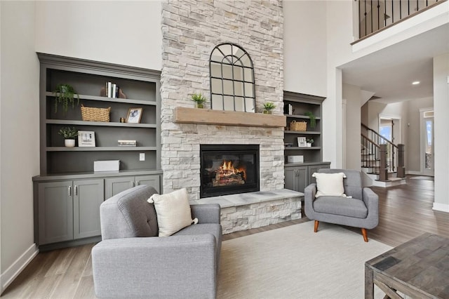 9660 Goehring Rd, Cranberry Twp, PA 16066 - living room featuring wood finished floors, stairs, a fireplace, baseboards, and a high ceiling