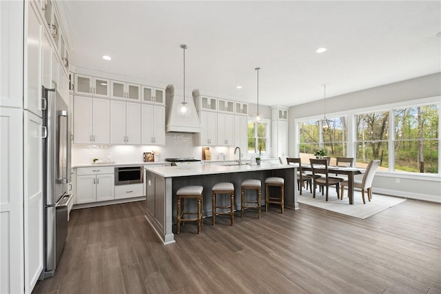 9660 Goehring Rd, Cranberry Twp, PA 16066 - kitchen with a sink, premium range hood, light countertops, dark wood-type flooring, and recessed lighting