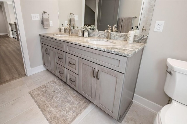 9660 Goehring Rd, Cranberry Twp, PA 16066 - bathroom featuring toilet, double vanity, baseboards, and tile patterned flooring