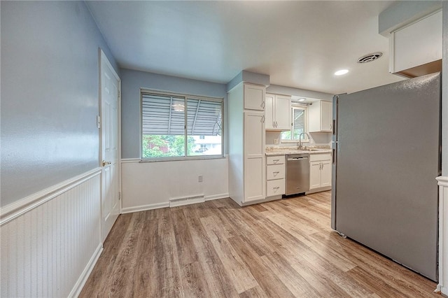 111 York Way, Center Twp Bea, PA 15061 - kitchen with stainless steel appliances, light wood-style flooring, white cabinets, and light countertops