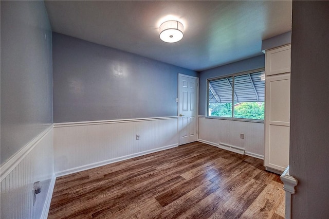 111 York Way, Center Twp Bea, PA 15061 - spare room with wood finished floors, a baseboard heating unit, a wainscoted wall, and baseboards