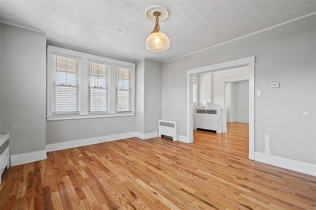 3565 Gerber Ave, Brighton Heights, PA 15212 - spare room featuring radiator, crown molding, light wood-style floors, baseboards, and a textured ceiling