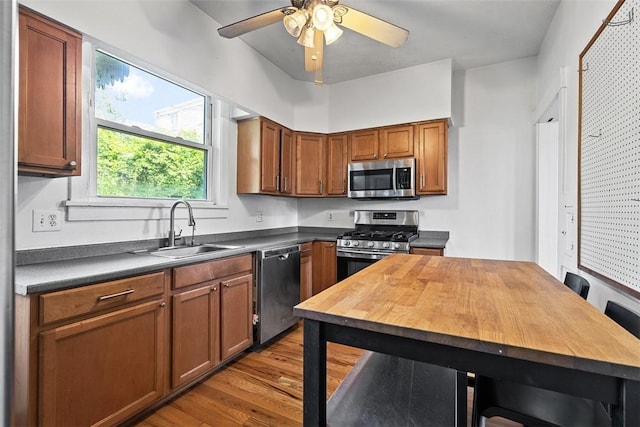 3565 Gerber Ave, Brighton Heights, PA 15212 - kitchen featuring stainless steel appliances, a sink, wood finished floors, ceiling fan, and brown cabinetry