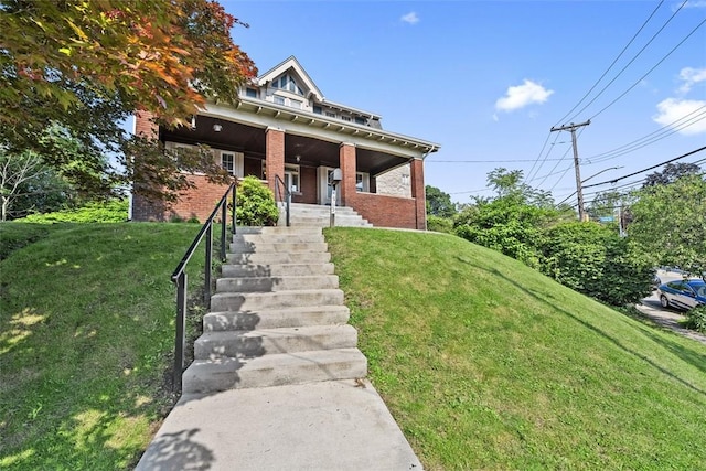 3565 Gerber Ave, Brighton Heights, PA 15212 - view of front of home with a front lawn, brick siding, a porch, and stairway
