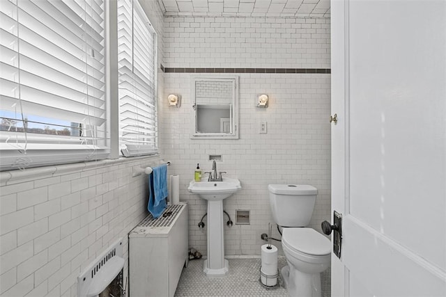 3565 Gerber Ave, Brighton Heights, PA 15212 - bathroom with tile walls, toilet, tile patterned floors, and radiator
