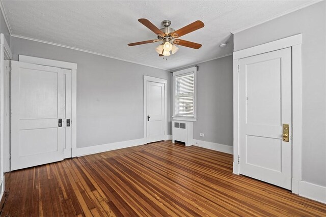 3565 Gerber Ave, Brighton Heights, PA 15212 - unfurnished bedroom featuring radiator heating unit, crown molding, baseboards, wood finished floors, and ceiling fan