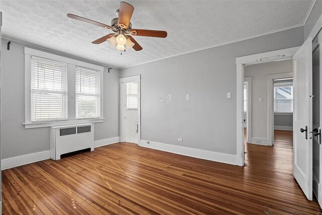 3565 Gerber Ave, Brighton Heights, PA 15212 - unfurnished room with radiator heating unit, a textured ceiling, a ceiling fan, wood finished floors, and baseboards