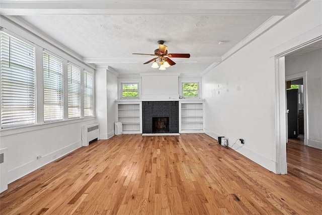3565 Gerber Ave, Brighton Heights, PA 15212 - unfurnished living room featuring radiator, a brick fireplace, light wood-style floors, a ceiling fan, and crown molding