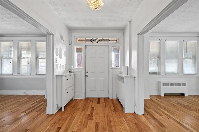 3565 Gerber Ave, Brighton Heights, PA 15212 - entrance foyer featuring radiator, a textured ceiling, light wood-style flooring, and baseboards