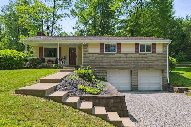 652 Westland Dr, Richland, PA 15044 - view of front facade with driveway, a garage, stone siding, a front yard, and covered porch