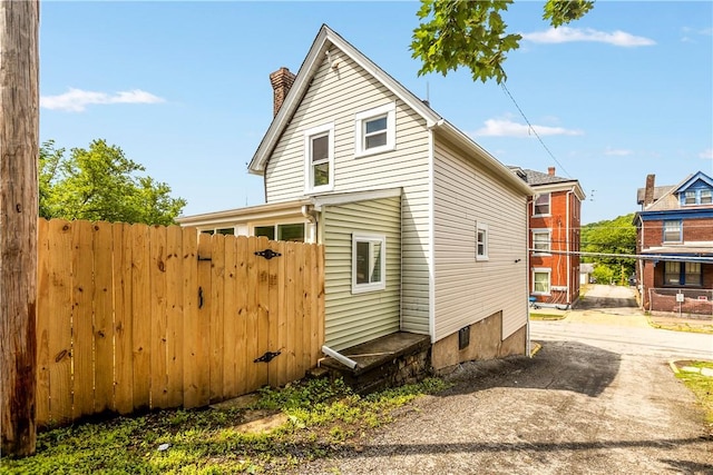 213 Highland Ave, Pitcairn, PA 15140 - view of property exterior with a chimney