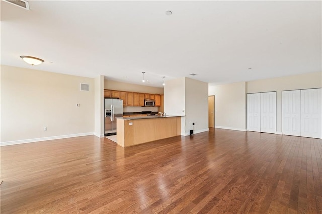 5570 Centre Ave Unit 306, Shadyside, PA 15232 - unfurnished living room featuring wood finished floors and baseboards