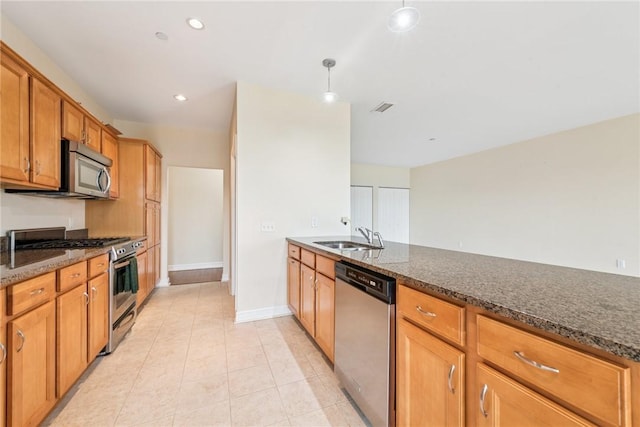 5570 Centre Ave Unit 306, Shadyside, PA 15232 - kitchen featuring appliances with stainless steel finishes, dark stone counters, light tile patterned flooring, recessed lighting, and pendant lighting
