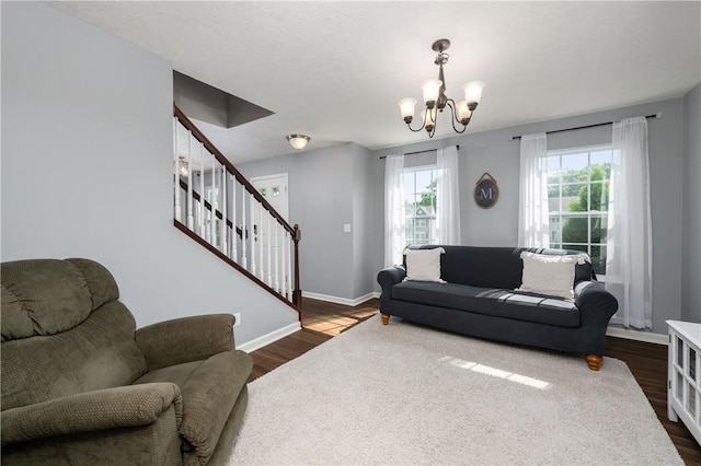 132 Naughton Cir, Forward Twp But, PA 16033 - living room with stairs, a chandelier, dark wood-type flooring, and baseboards