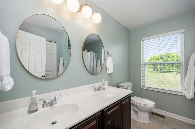 132 Naughton Cir, Forward Twp But, PA 16033 - bathroom featuring double vanity, healthy amount of natural light, toilet, and baseboards