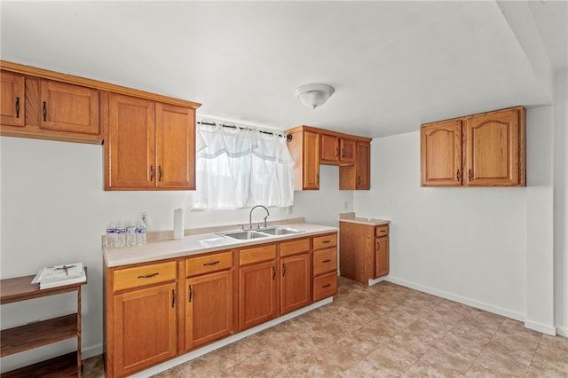 3316 Evans Dr, South Park, PA 15332 - kitchen with a sink, brown cabinetry, and light countertops