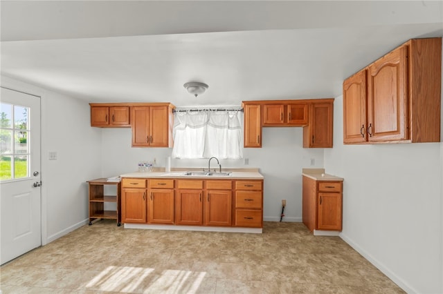 3316 Evans Dr, South Park, PA 15332 - kitchen with a sink, brown cabinets, baseboards, and light countertops