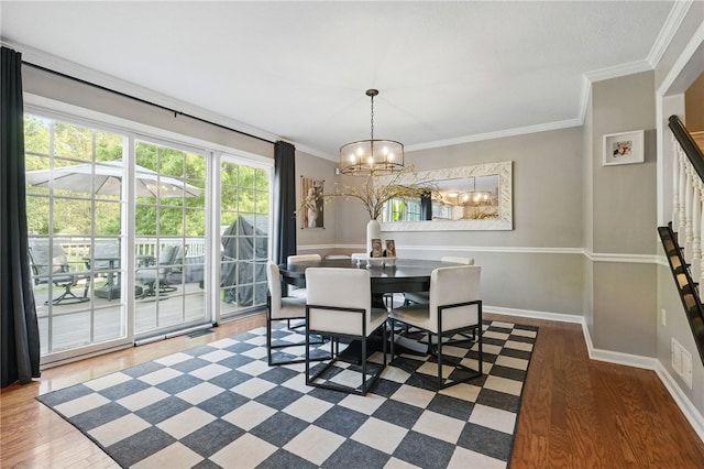 901 Montclair Dr, Moon/Crescent Twp, PA 15108 - dining space with a chandelier, wood finished floors, plenty of natural light, and ornamental molding