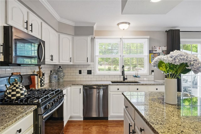 901 Montclair Dr, Moon/Crescent Twp, PA 15108 - kitchen with dishwasher, black gas range oven, a sink, ornamental molding, and light stone counters