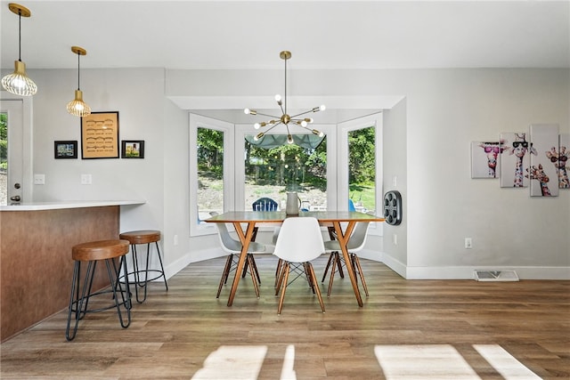 118 Eakin Ave, Ross Twp, PA 15214 - dining space featuring wood finished floors, a chandelier, and baseboards