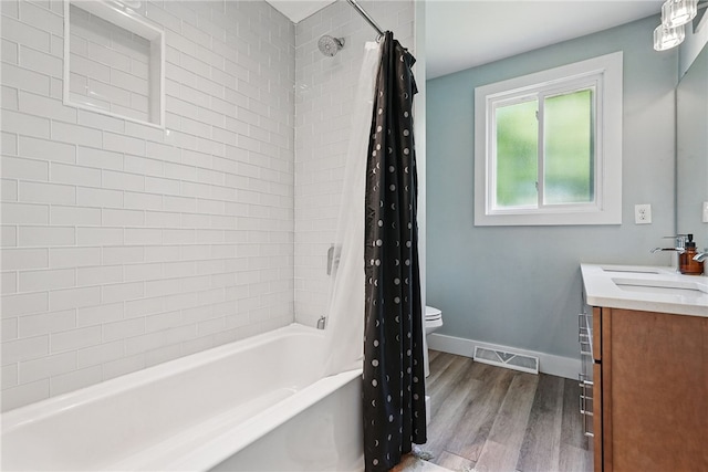 118 Eakin Ave, Ross Twp, PA 15214 - bathroom featuring wood finished floors, vanity, shower / tub combo, toilet, and baseboards