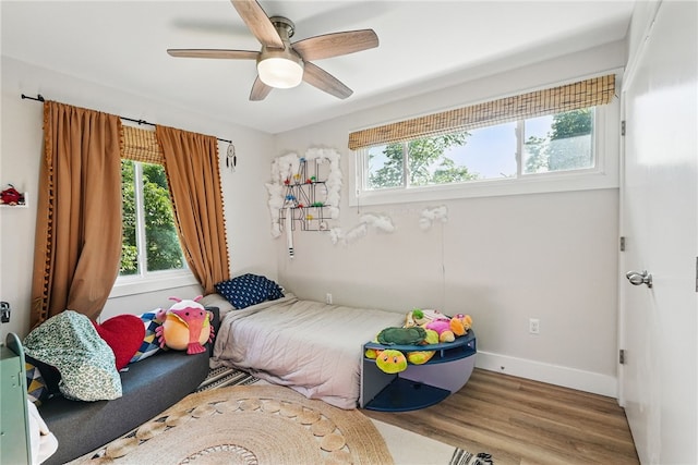 118 Eakin Ave, Ross Twp, PA 15214 - bedroom with multiple windows, wood finished floors, a ceiling fan, and baseboards