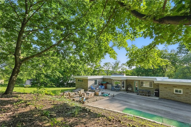 118 Eakin Ave, Ross Twp, PA 15214 - rear view of property featuring a patio area and stone siding