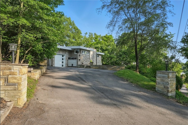 118 Eakin Ave, Ross Twp, PA 15214 - view of front of home featuring driveway, stone siding, and a garage