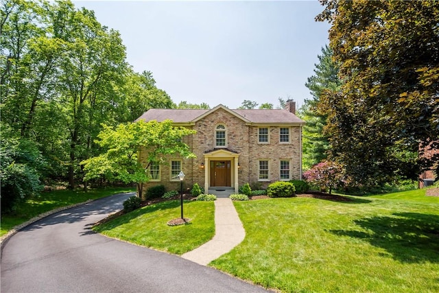 511 Clubview Dr, Peters Twp, PA 15317 - view of front of house with a chimney, a front yard, and brick siding
