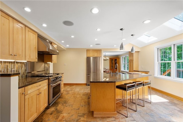 511 Clubview Dr, Peters Twp, PA 15317 - kitchen with premium appliances, a skylight, exhaust hood, a kitchen bar, and a sink