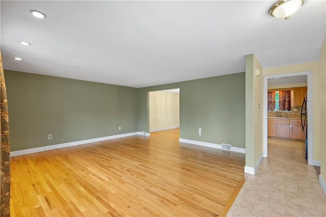1064 Glen Oak Dr, Bethel Park, PA 15102 - unfurnished room with a sink, baseboards, recessed lighting, and light wood finished floors
